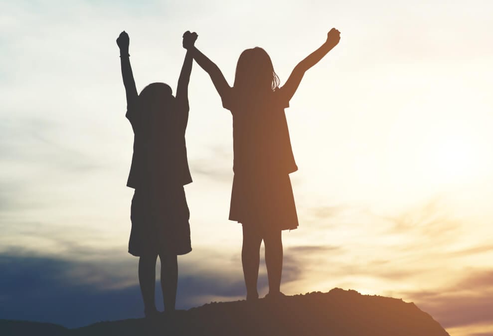 silhouette-two-girl-having-fun-nature 1